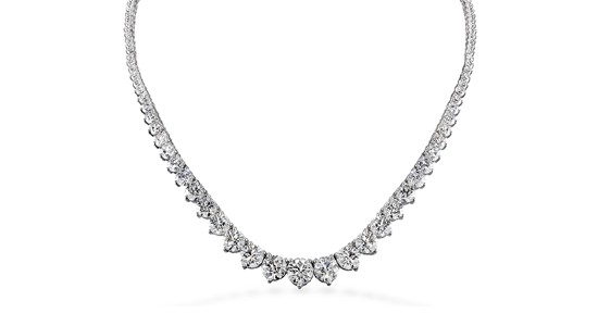 Silver diamond necklace with a number of stones of different sizes, the largest situated at the center