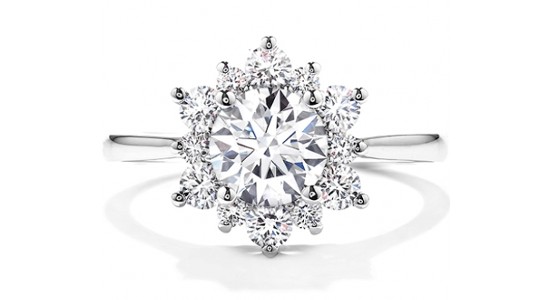 a white gold engagement ring with a halo of diamonds that resembles a snowflake