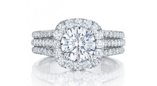 a white gold engagement ring with a halo and three rows of side stones
