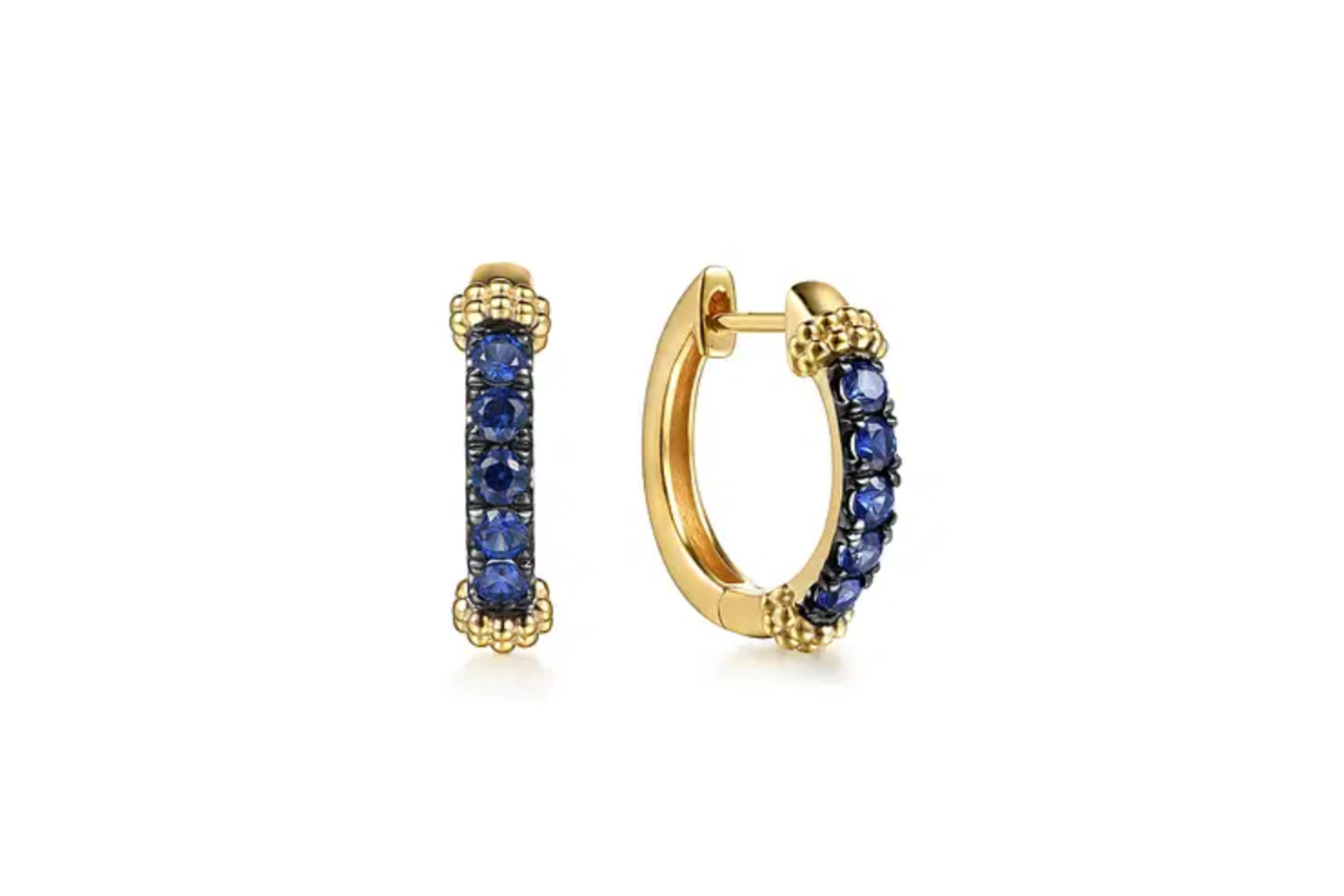 Gold huggies with blue sapphire stones.