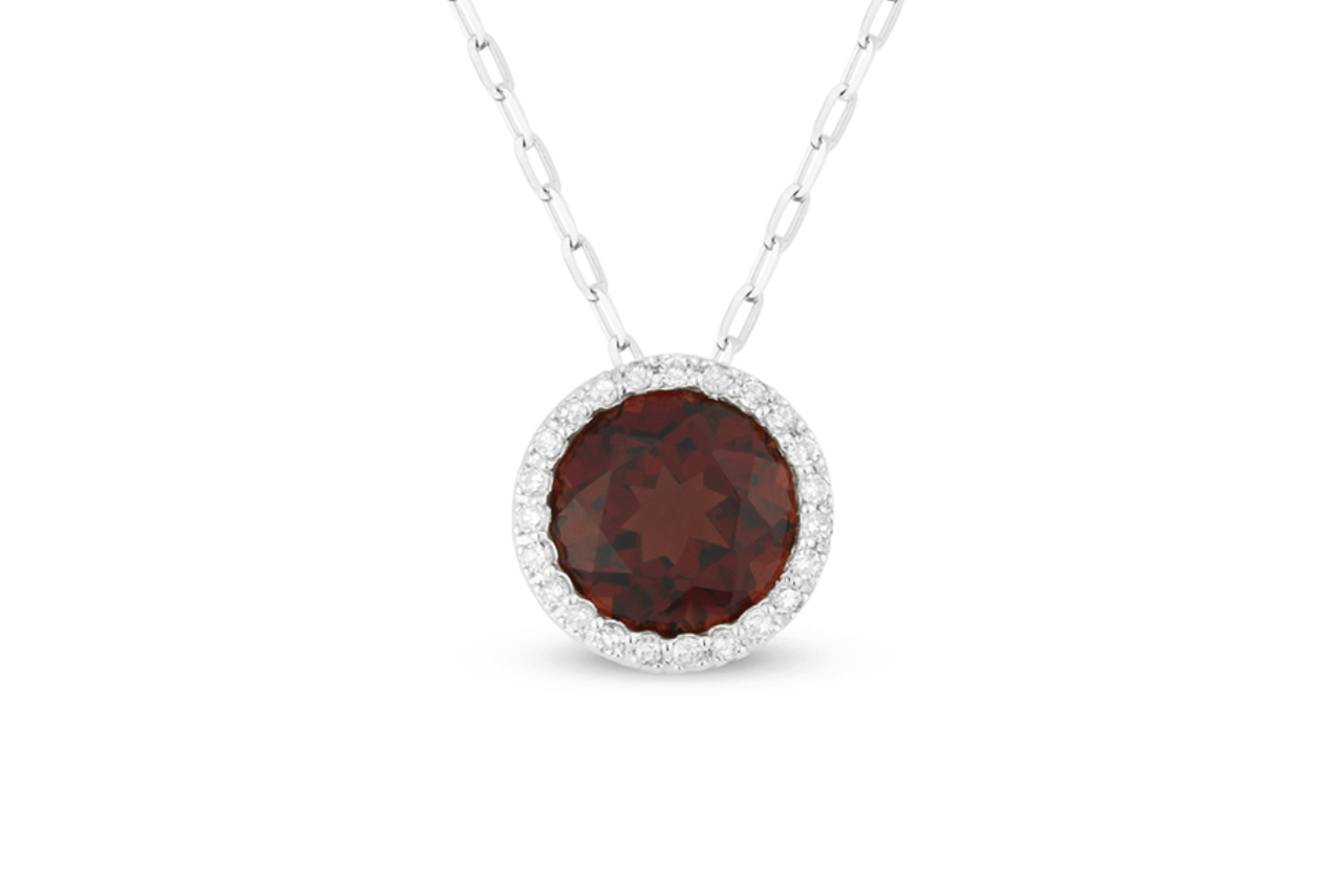 A silver pendant with a circular garnet center stone and a diamond halo.