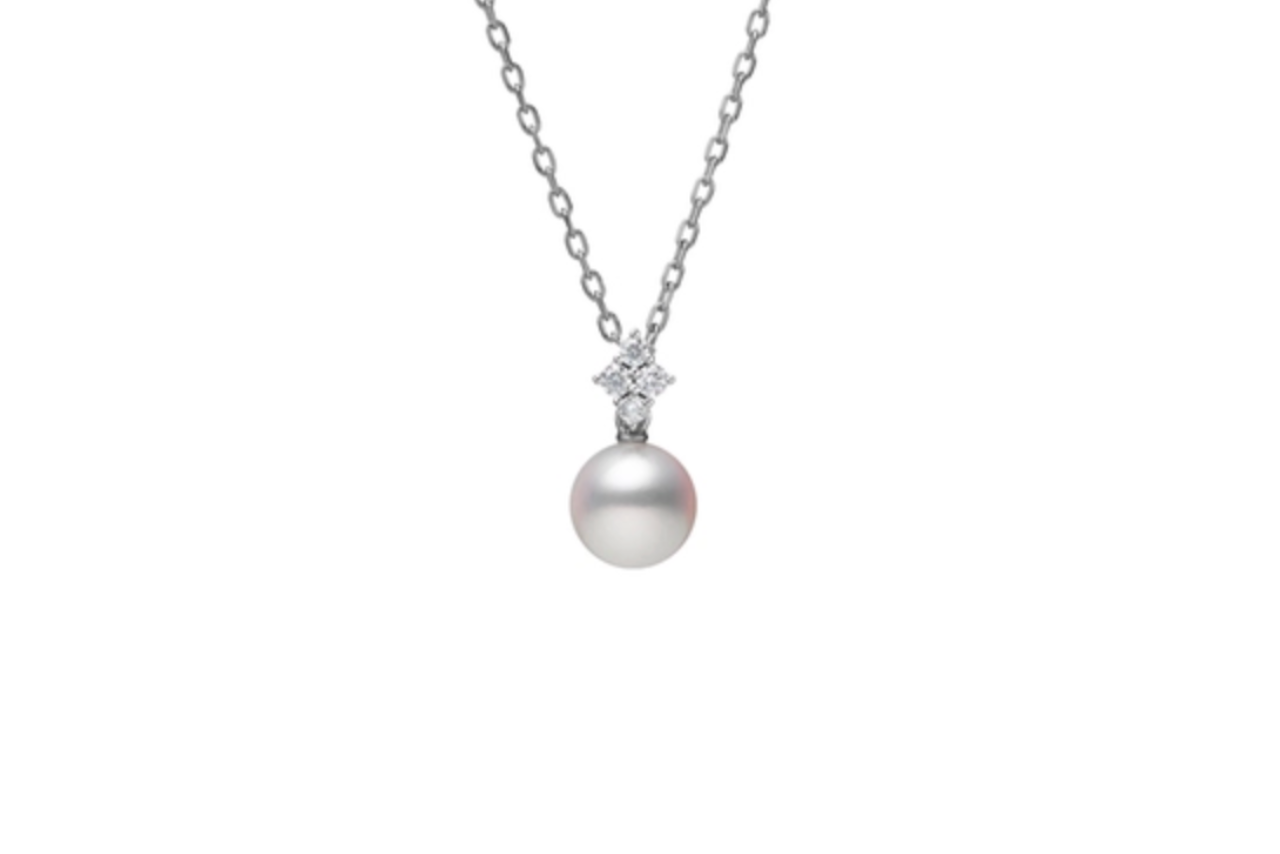 A white gold, pearl, and diamond pendant.