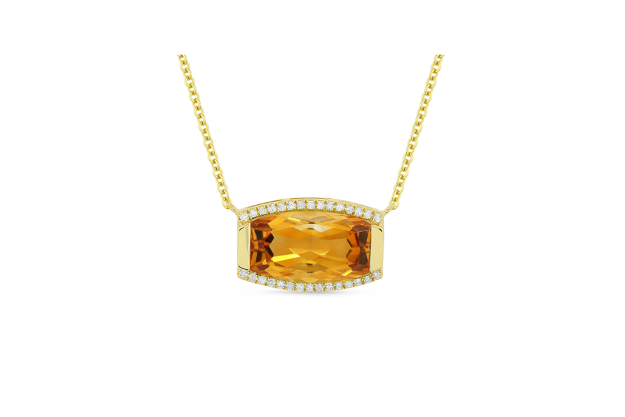 A golden necklace with a citrine stone pendant.
