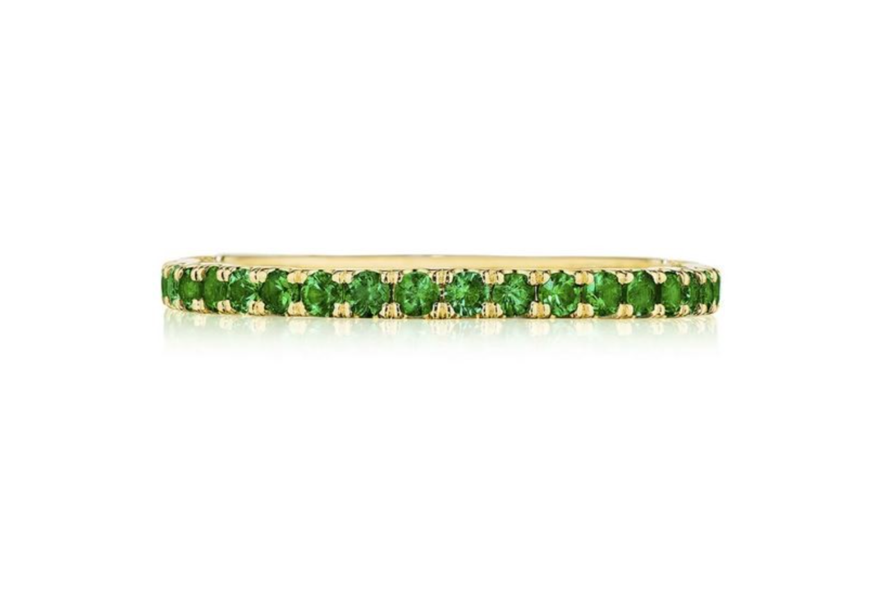 A yellow gold crescent channel-set emerald band.