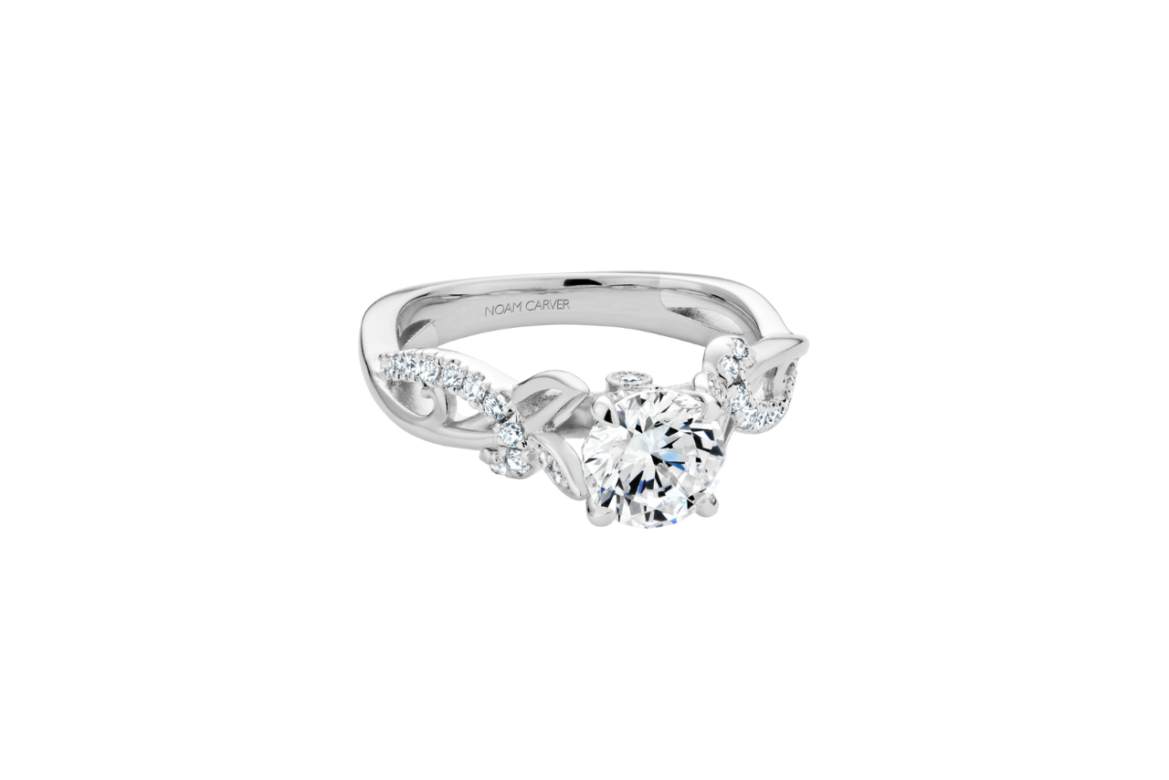 A stunning engagement ring with floral-like metalwork on the band.