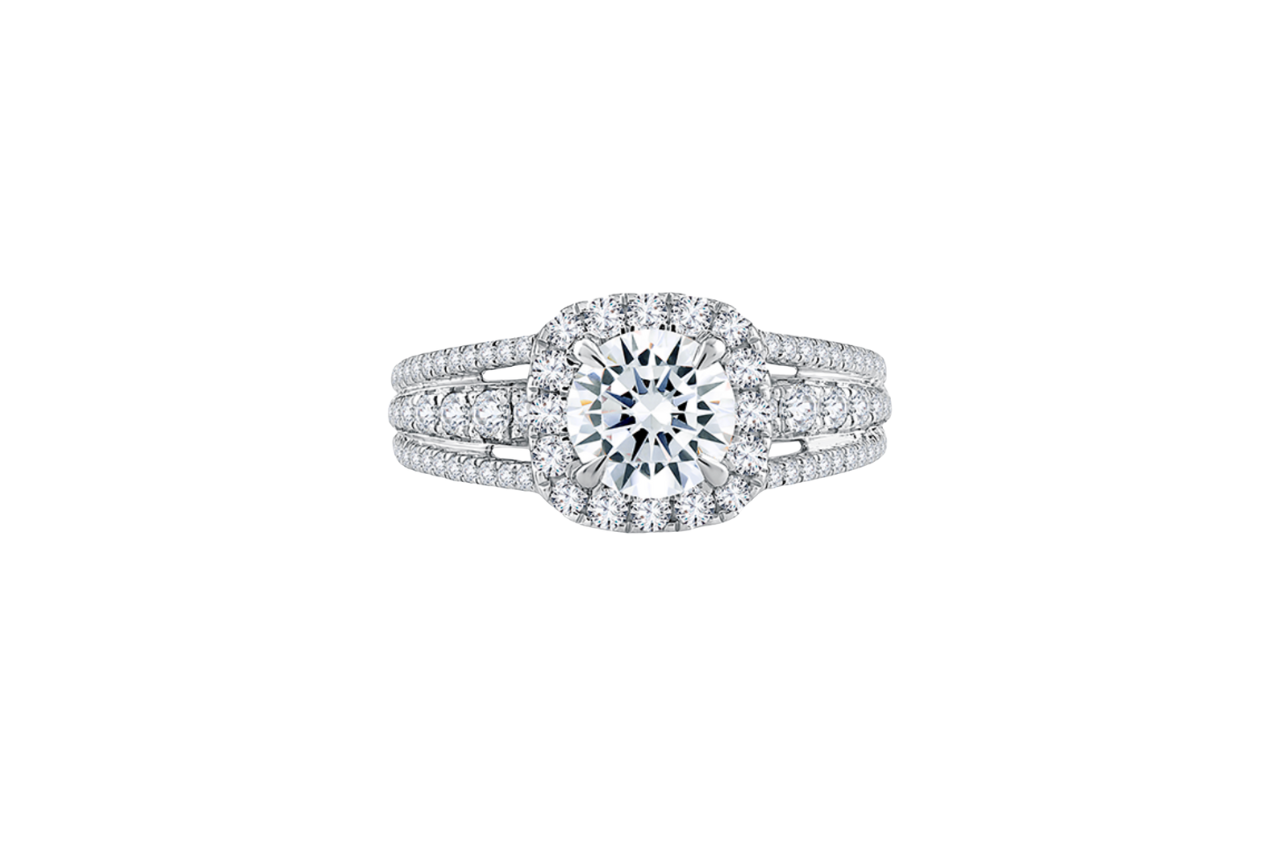 A vintage-inspired engagement ring, with a large center stone surrounded by a halo, and a diamond-filled band.