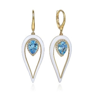 A pair of blue topaz earrings with white enamel and 14k yellow gold.