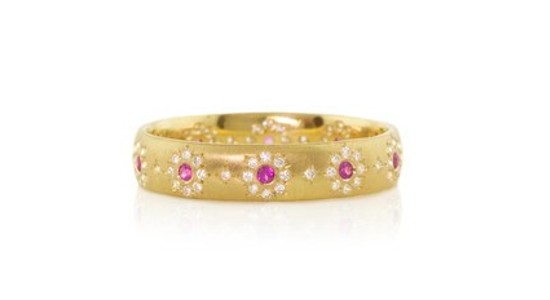 a yellow gold fashion ring featuring pink rubies and diamond accents in the shape of flowers
