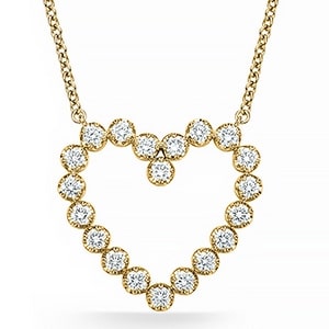 a yellow gold heart pendant with diamond accents from Memoire.