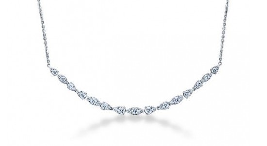 a silver diamond necklace in bezel settings of various shapes