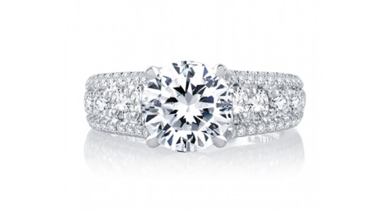 a white gold engagement ring with a round cut center stone and thick band