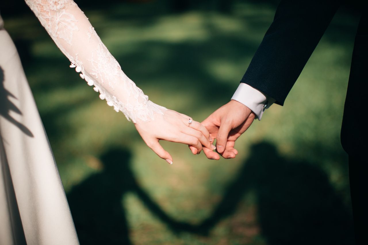 a bride and groom holdings hands