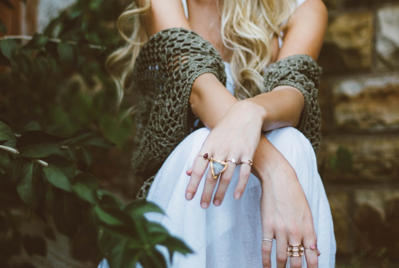 Lady in a fashionable outfit shows off a well-designed fashion ring stack