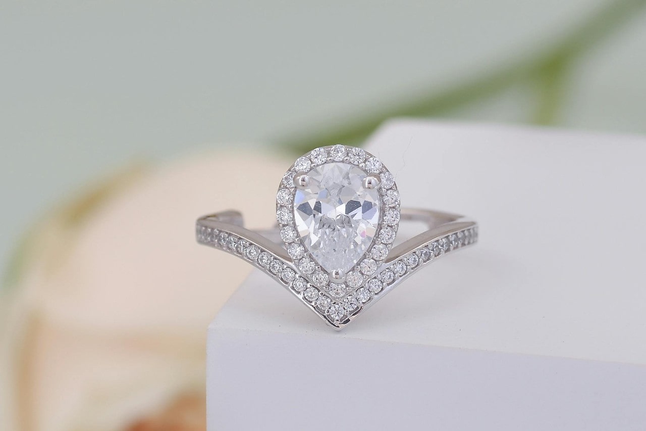 a white gold pear shape engagement ring with an unusual silhouette